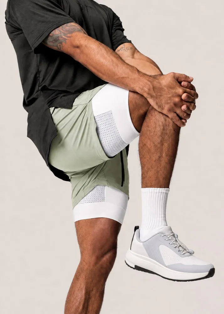 Studio shot, stretching in light trainers