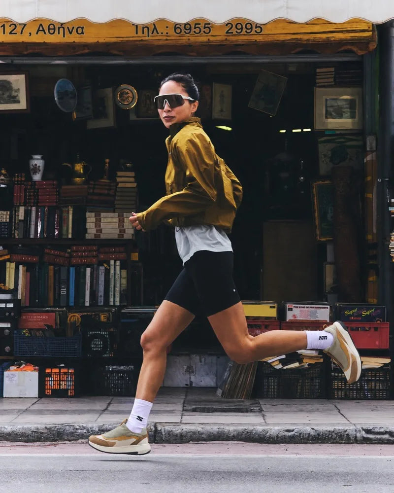 Running past a shopfront on a city street