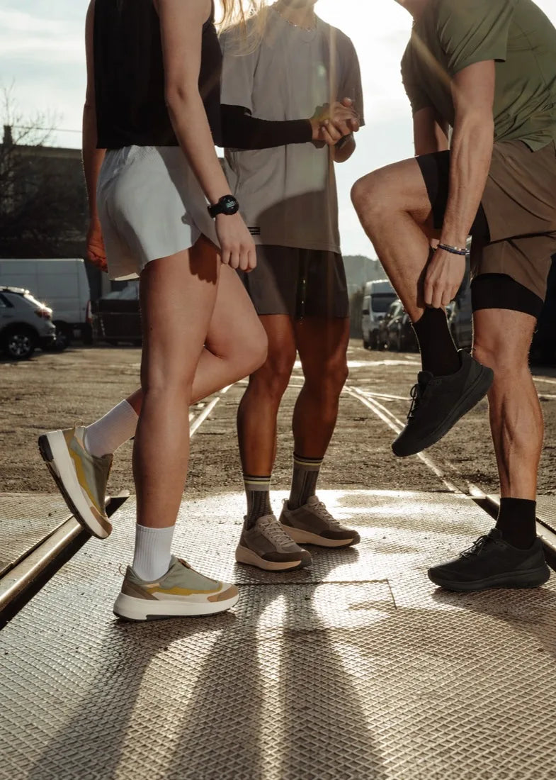 Three runners together in low morning light