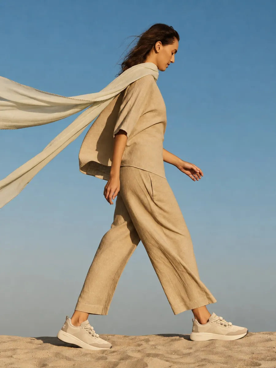 Walking on sand with a scarf in the wind
