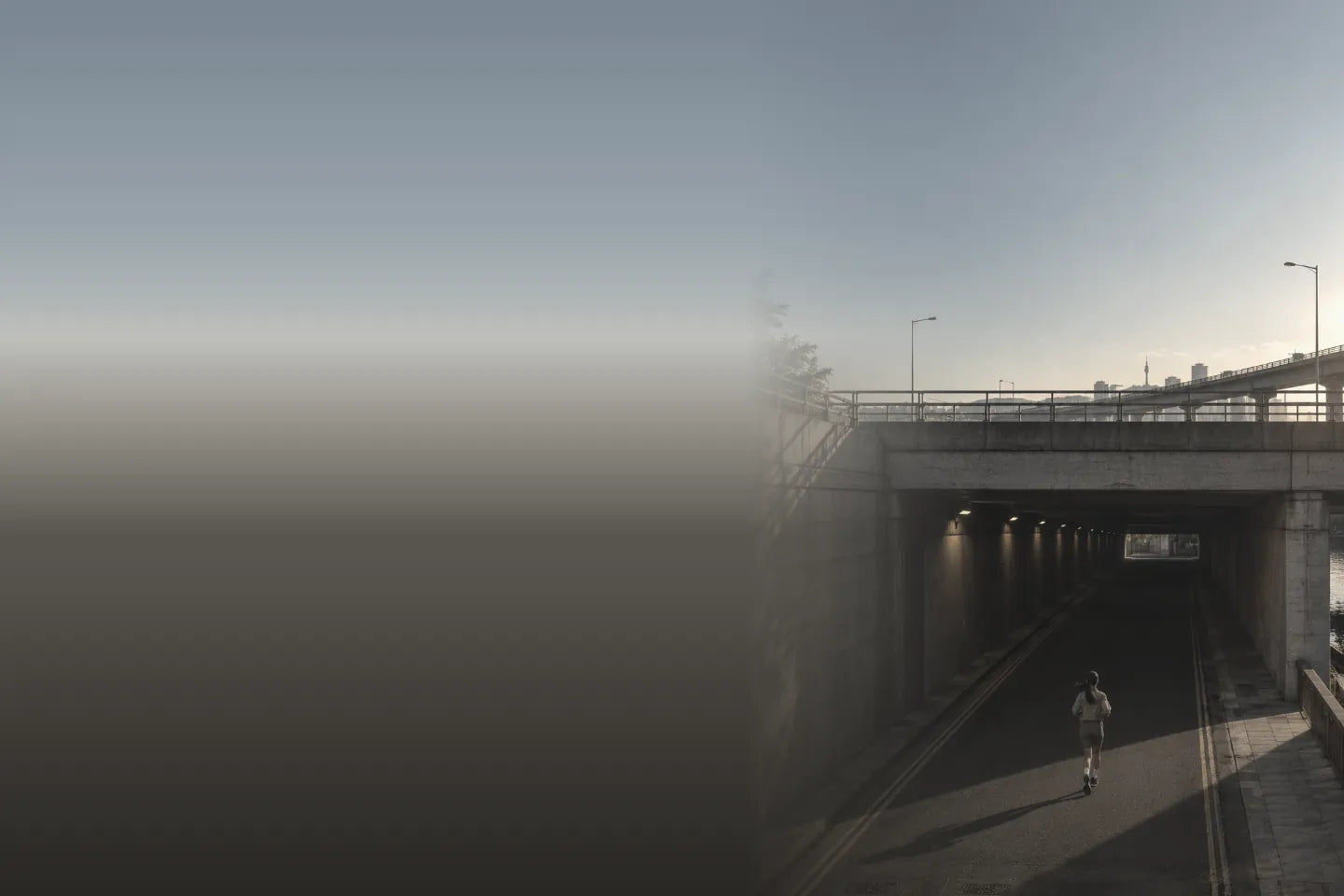 Runner heading into an underpass by the river in Seoul at golden hour