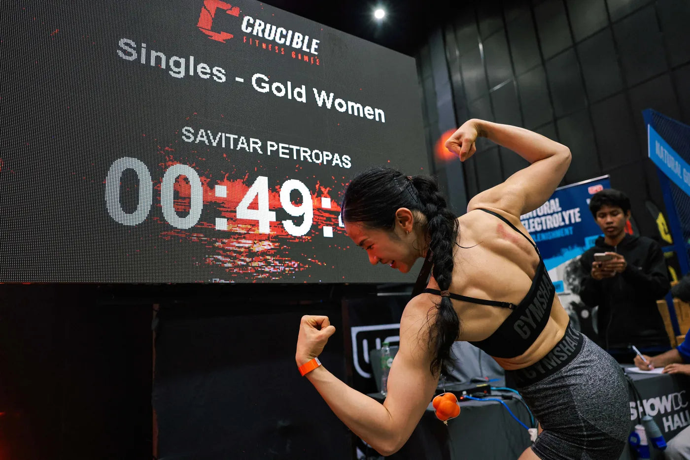 Athlete celebrating her finish at Crucible Fitness Games