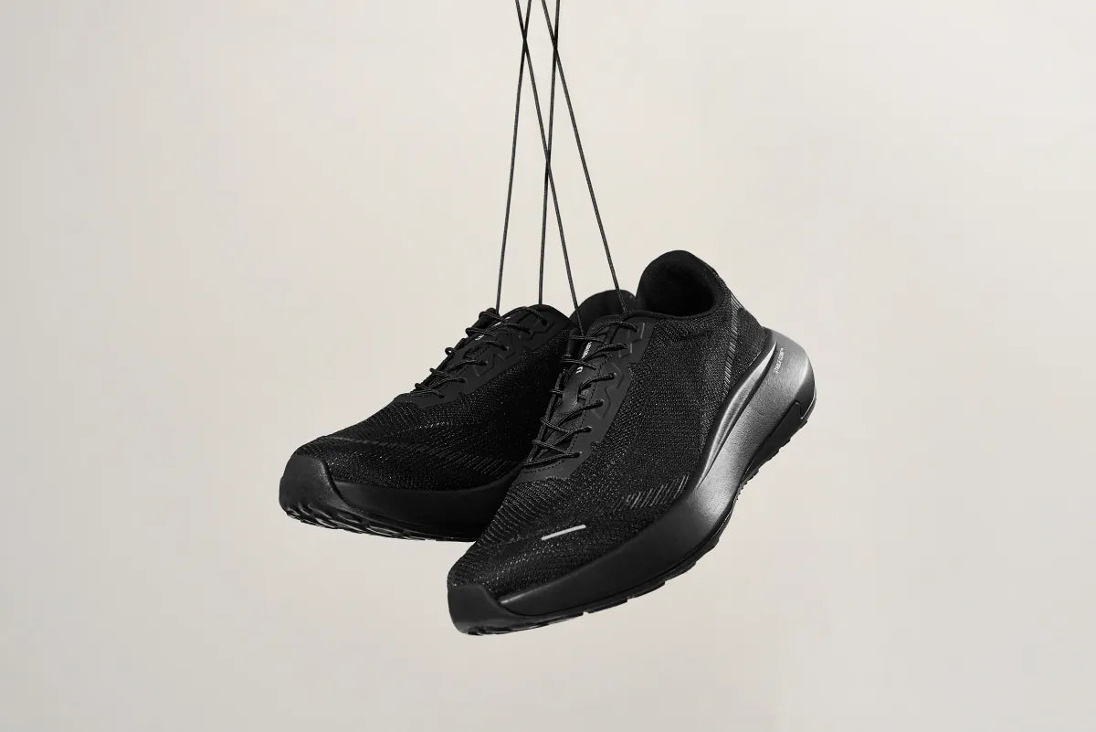 VT-001 pair hanging by the laces, showing the breathable knit upper